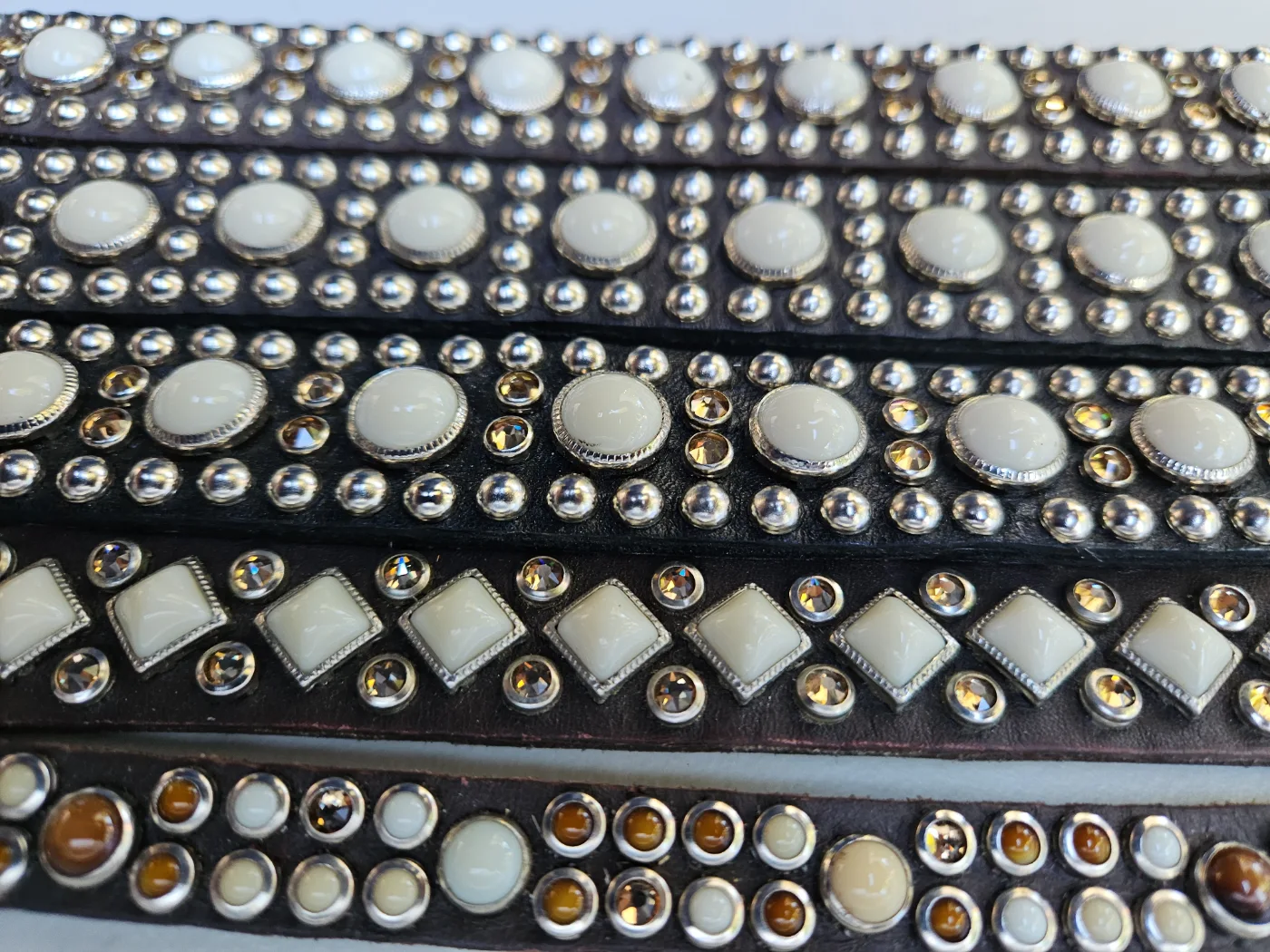 RN Design Cafe Latte Collection leather collars with white accents and metallic studs, close-up